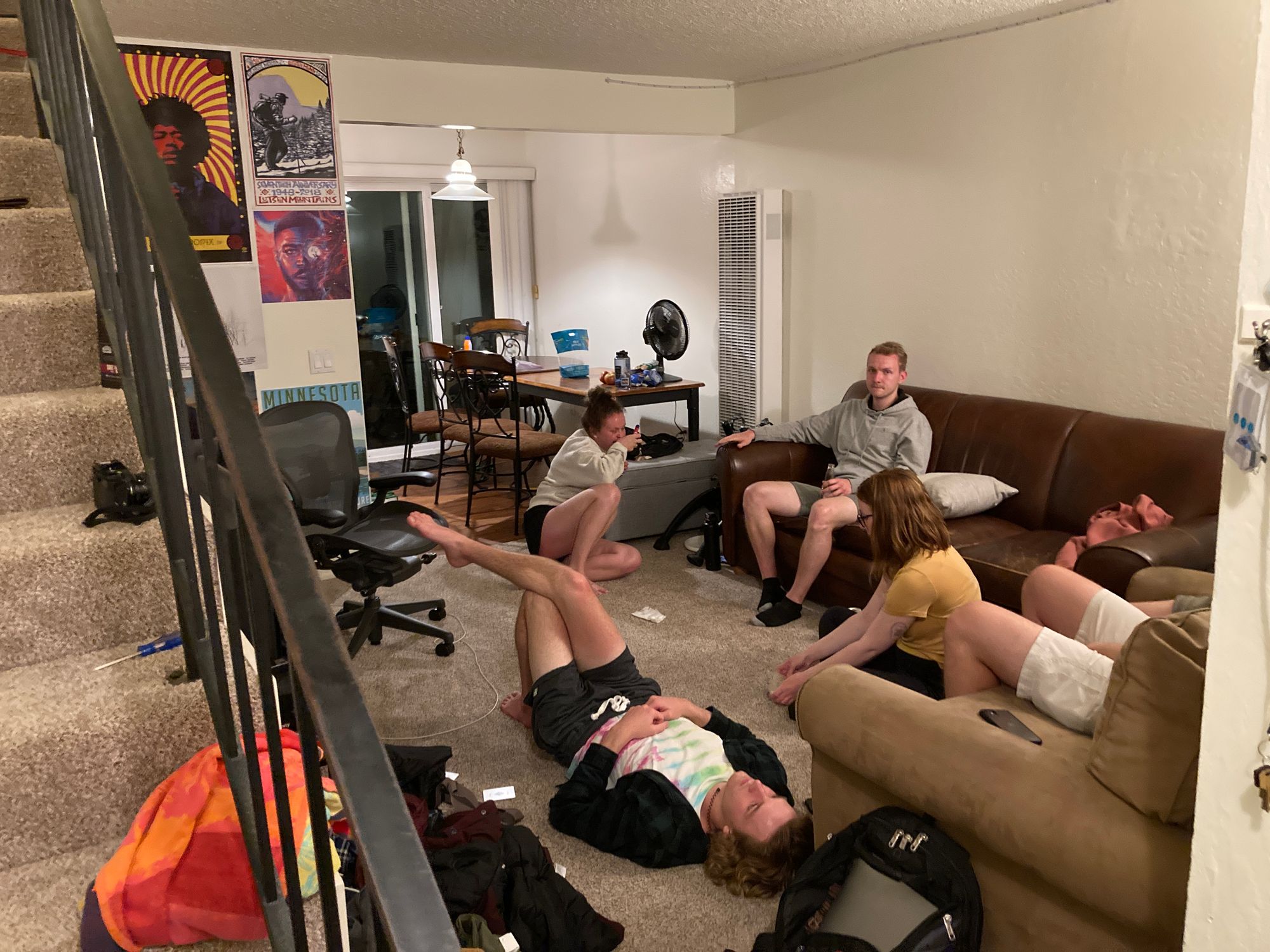 Friends relaxing on apartment floor in California